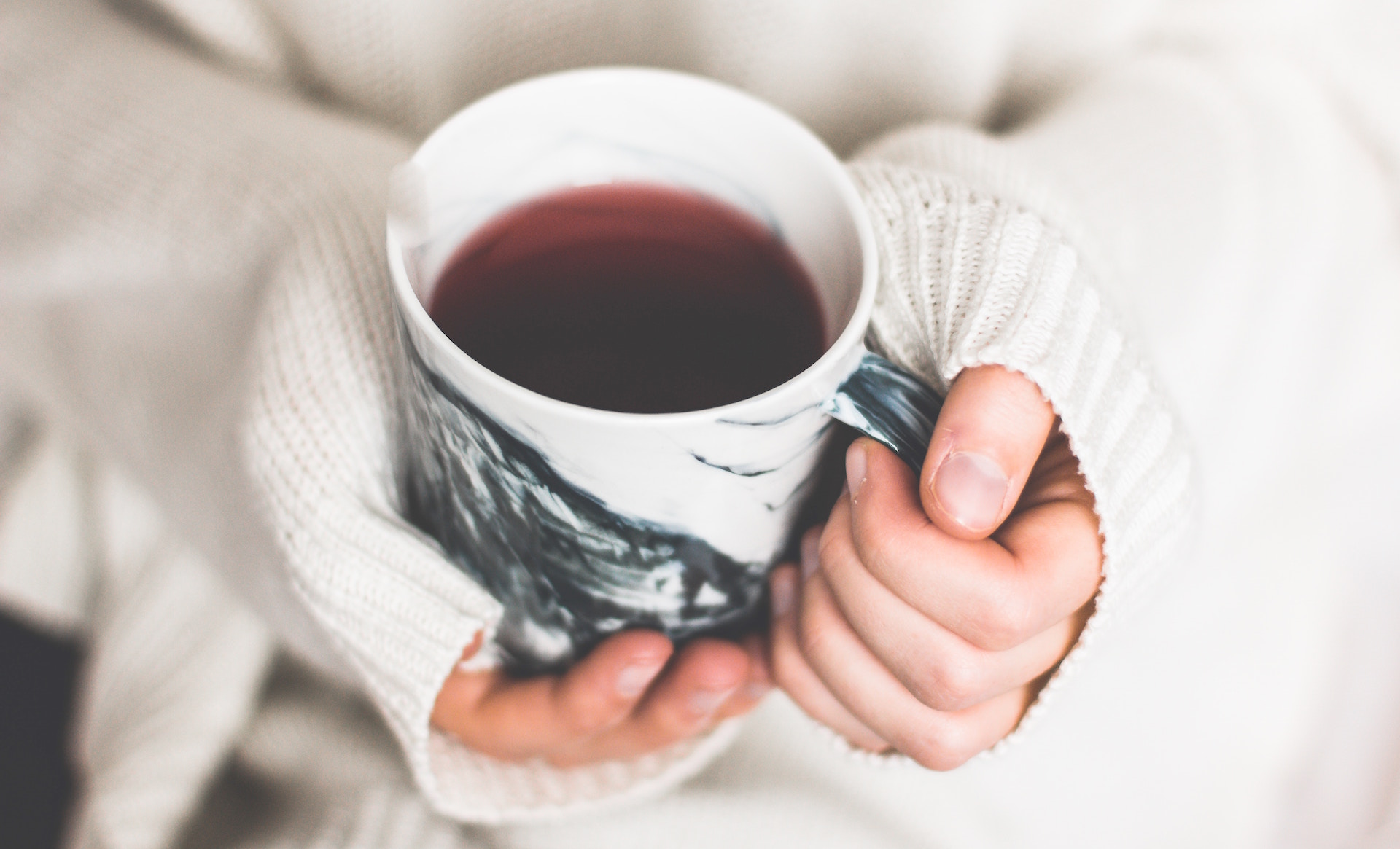 holding a cup of warming tea of spices