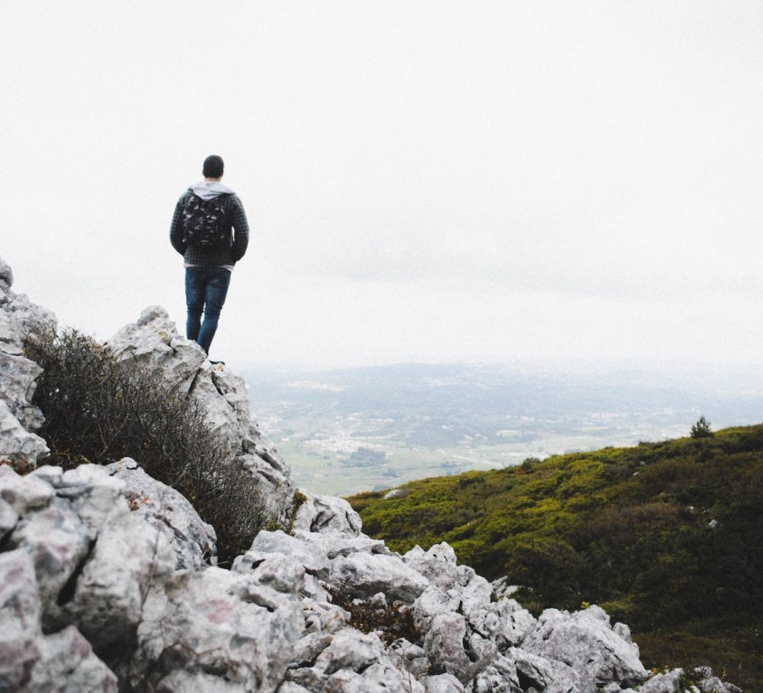 man standing on a peak