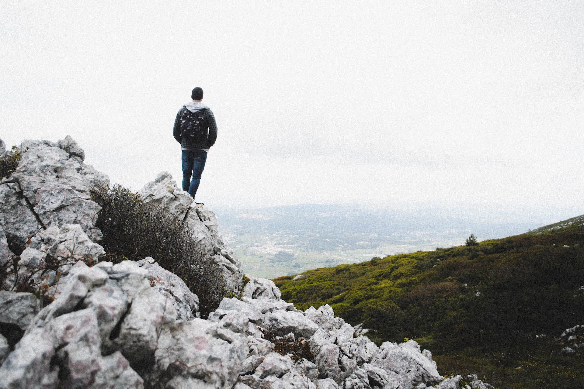 man standing on a peak