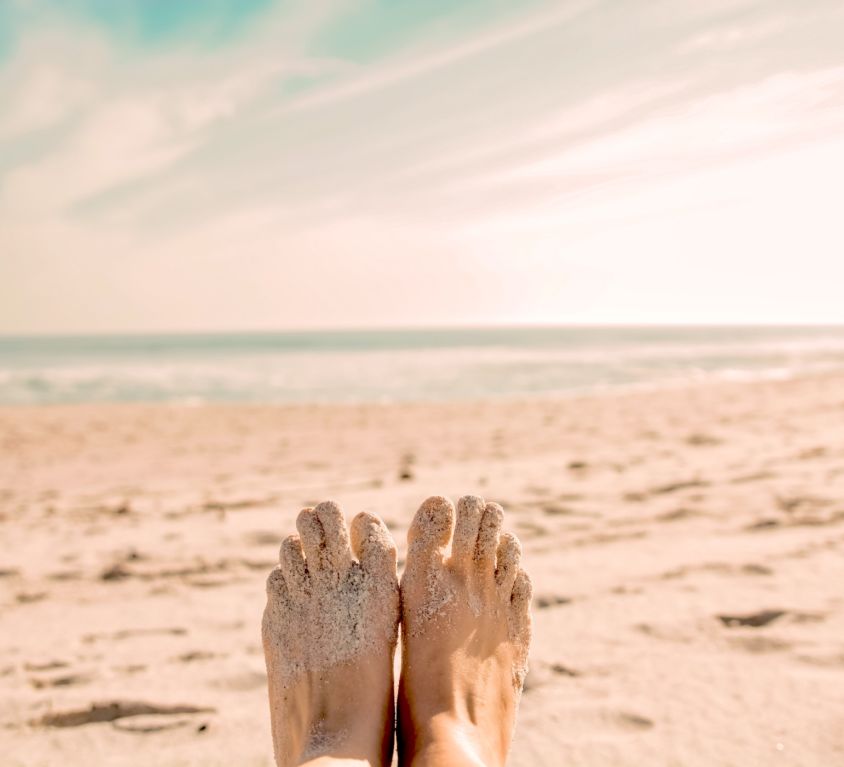 toe tapping at the beach to release energy and calm the mind