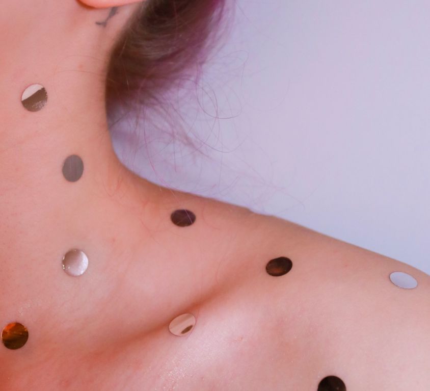 woman with gold dots on her neck and shoulders (dragon's blood wound healing article)